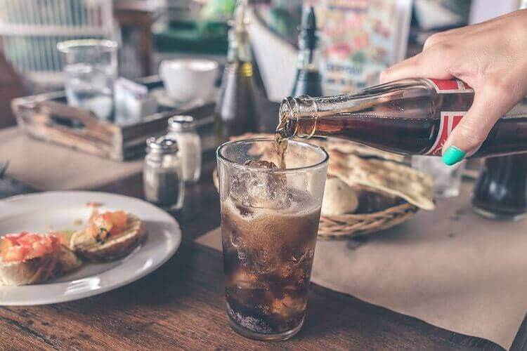 coke cola poured into a glass